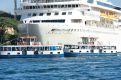 ferriies alongside the cruise ship