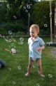 little boy between soapbubbles